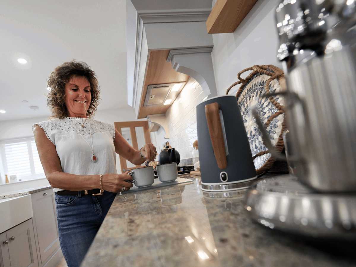 A delta customer making a cup of tea at home