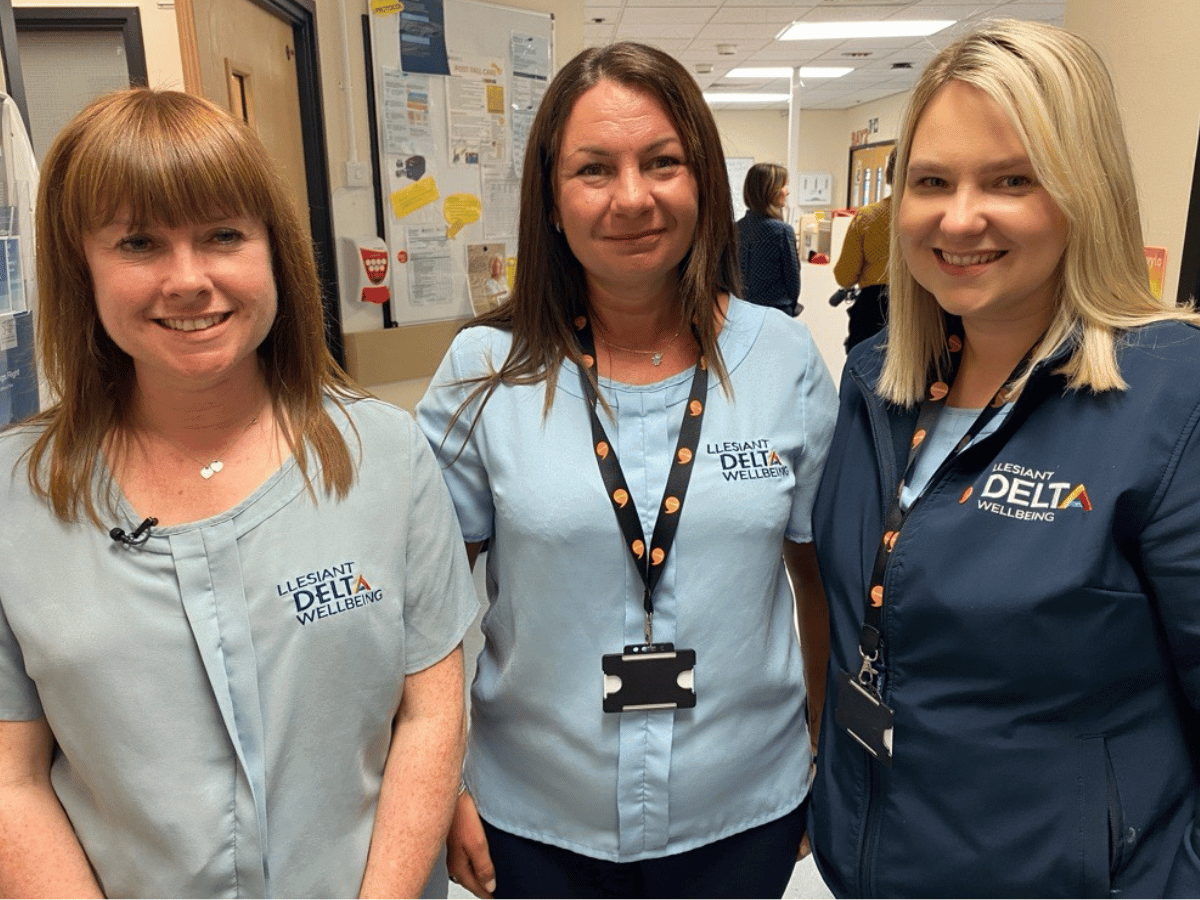 3 Delta staff in hospital scrubs