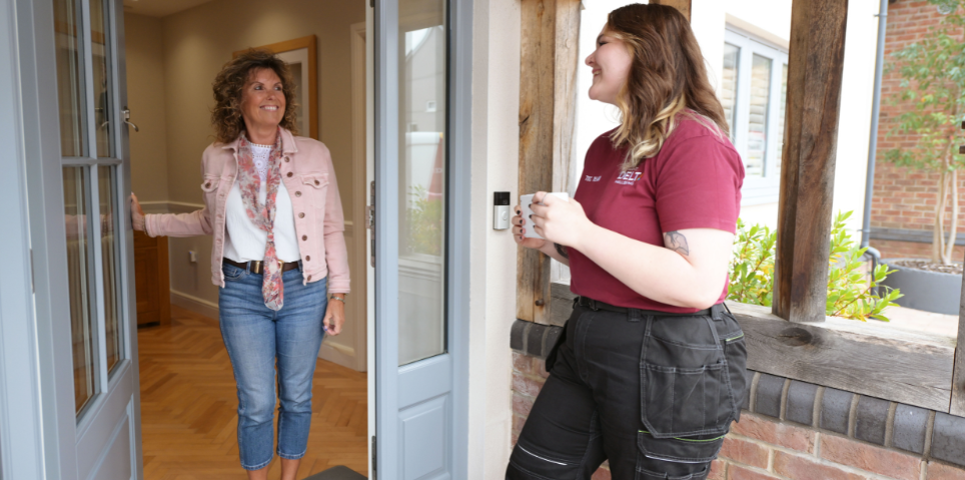 TEC Officer with woman at front door