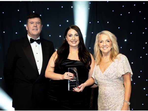 Charlotte holding her award