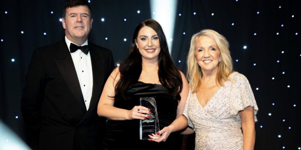 Charlotte holding her award