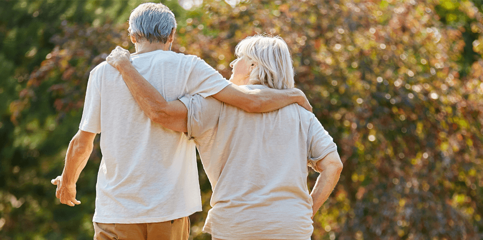Two older people walking together