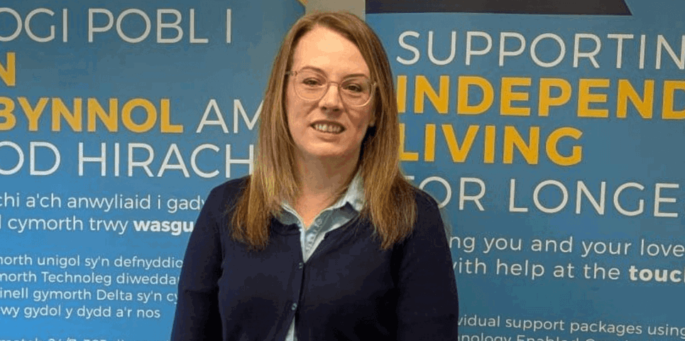 Female community wellbeing officer standing outside living well centre in Carmarthen