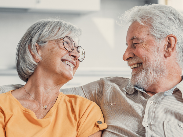 Older couple smiling and embracing one another