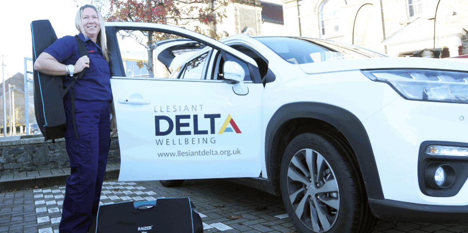 Female Response Officer standing by Delta Wellbeing car