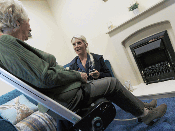 Female Responder lifting female customer with chair
