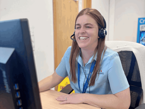 Delta Wellbeing adviser at her desk answering emergency calls